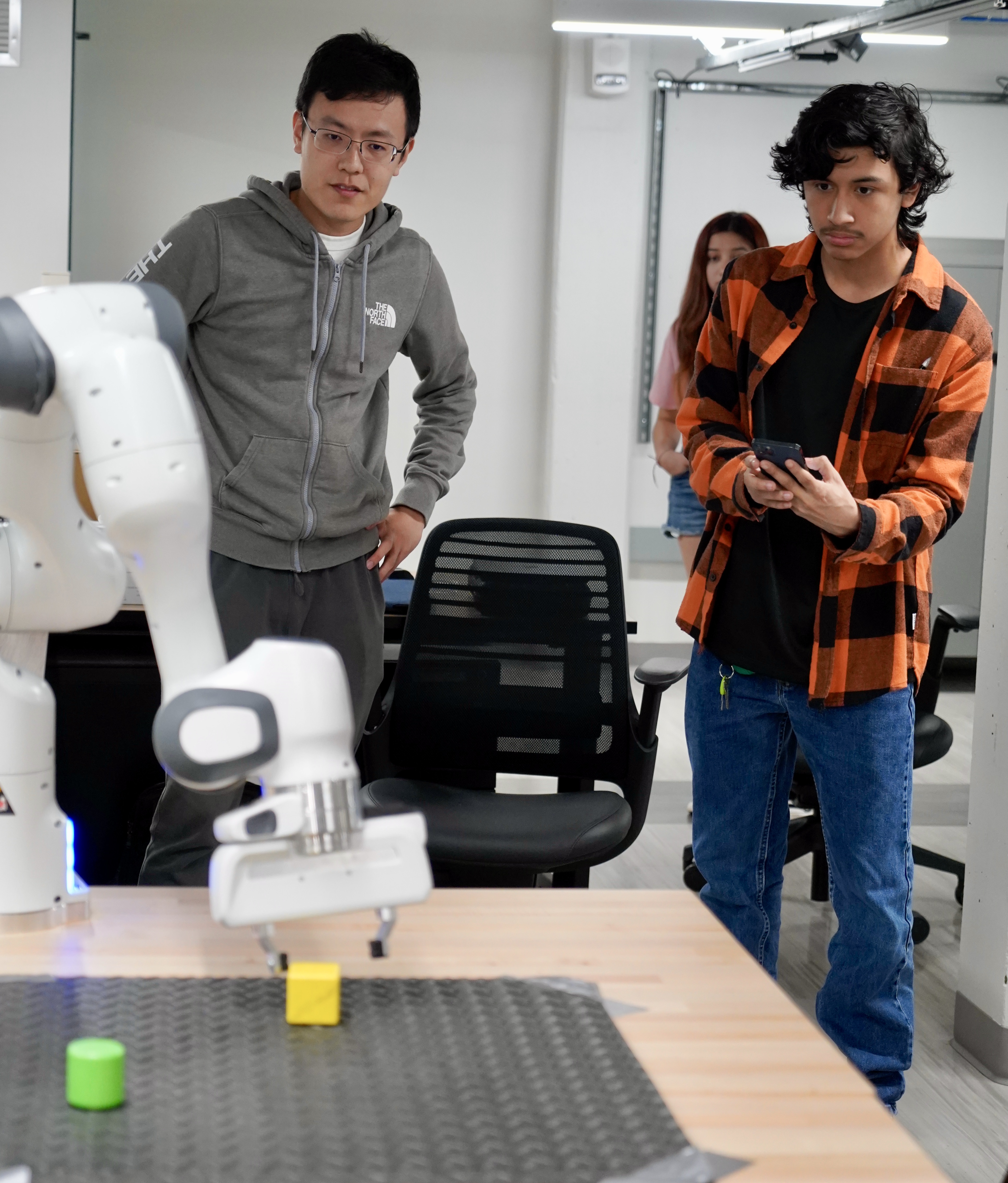 High school student Jacob Rodriguez controls a robotic arm with a smartphone app.