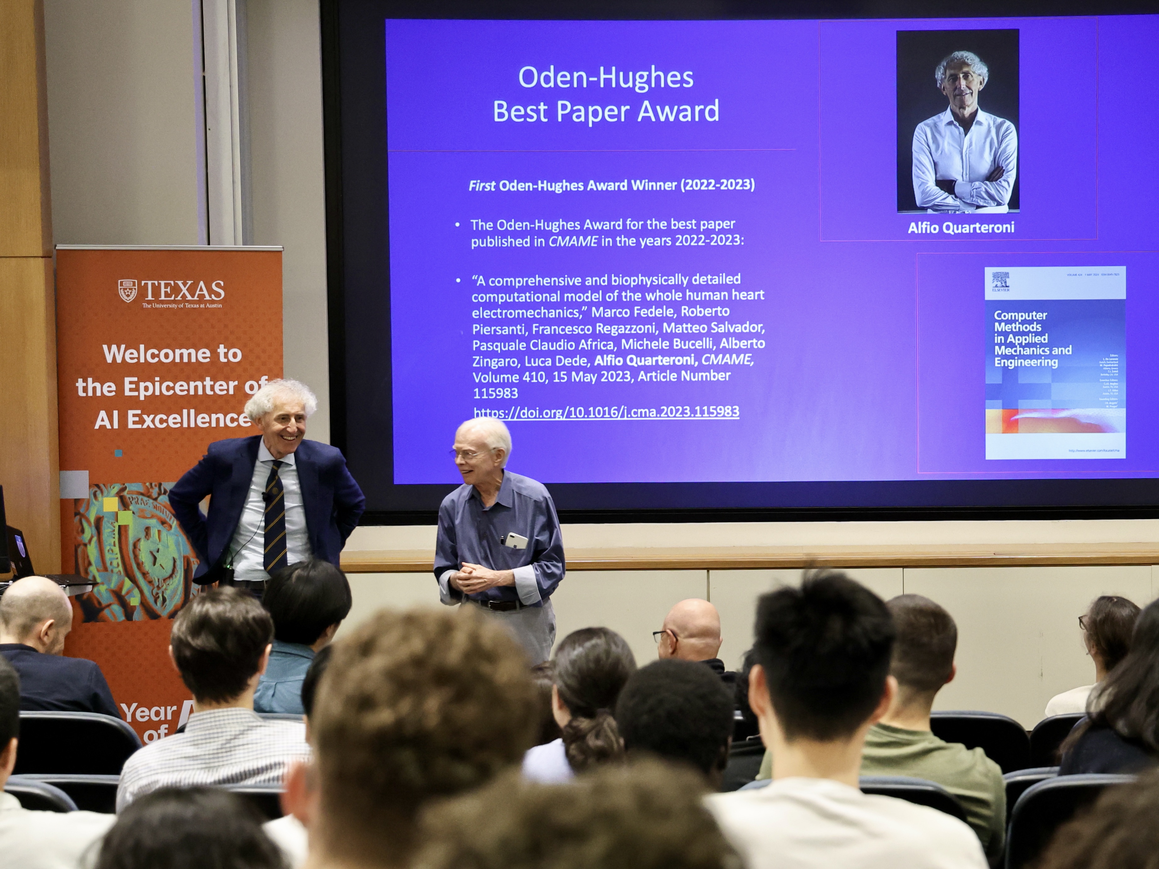 Hughes (r) congratulates Quarteroni in person during his visit to the Oden Institute. Credit: Joanne Foote.