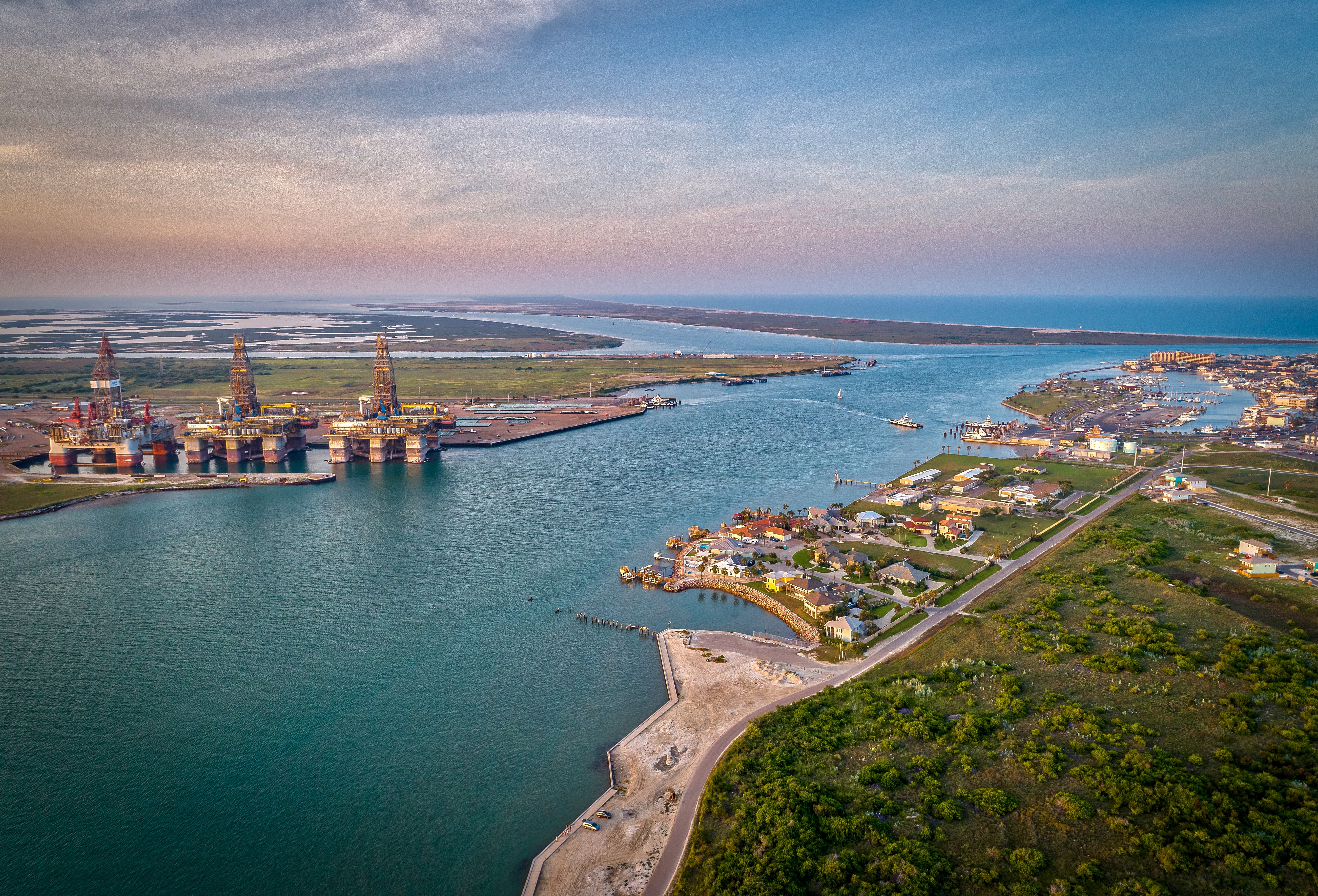 The natural inlet and ship channel splits San José Island and Mustang Island, near the Port Aransas Ferry crossing. Credit: Adobe Stock image.