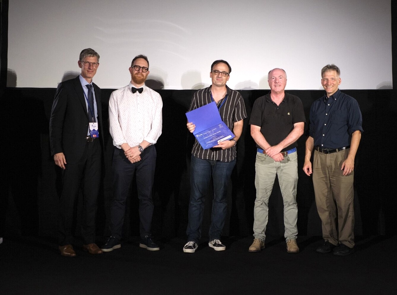 Renato Zanetti (center) accepted the Best Paper Award.